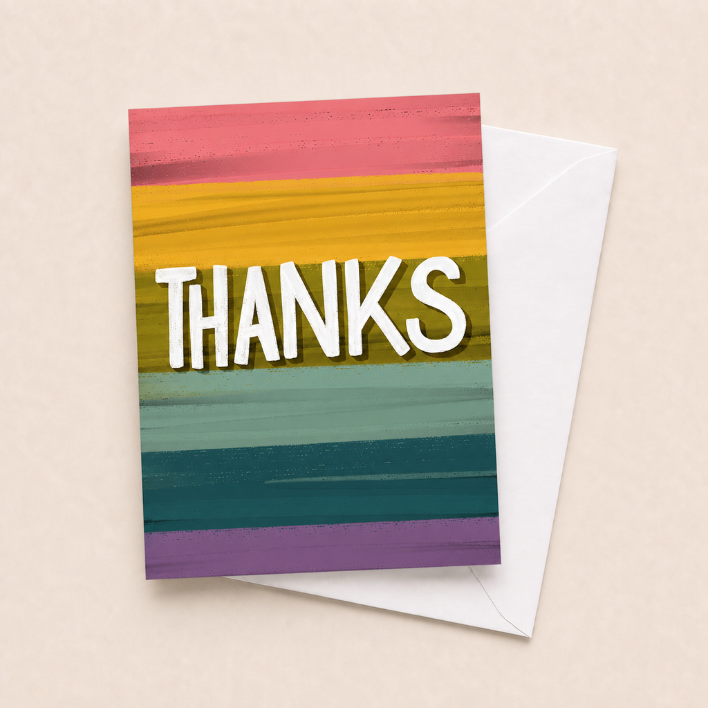 Colorful Thanks card with white envelope on a beige background